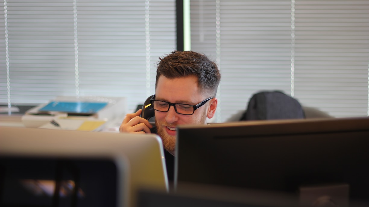 A customer support professional speaking on the phone